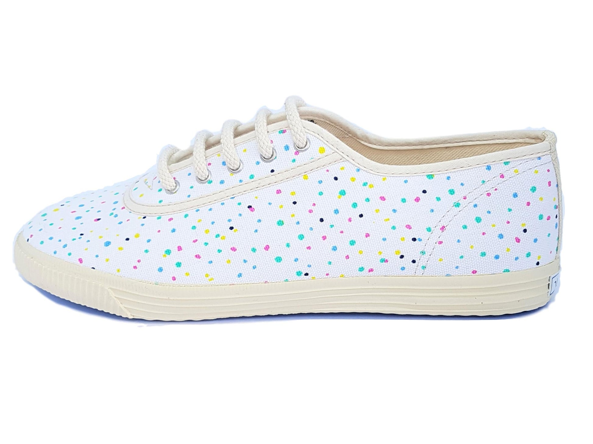 White sneaker with colorful polka dots on a white background